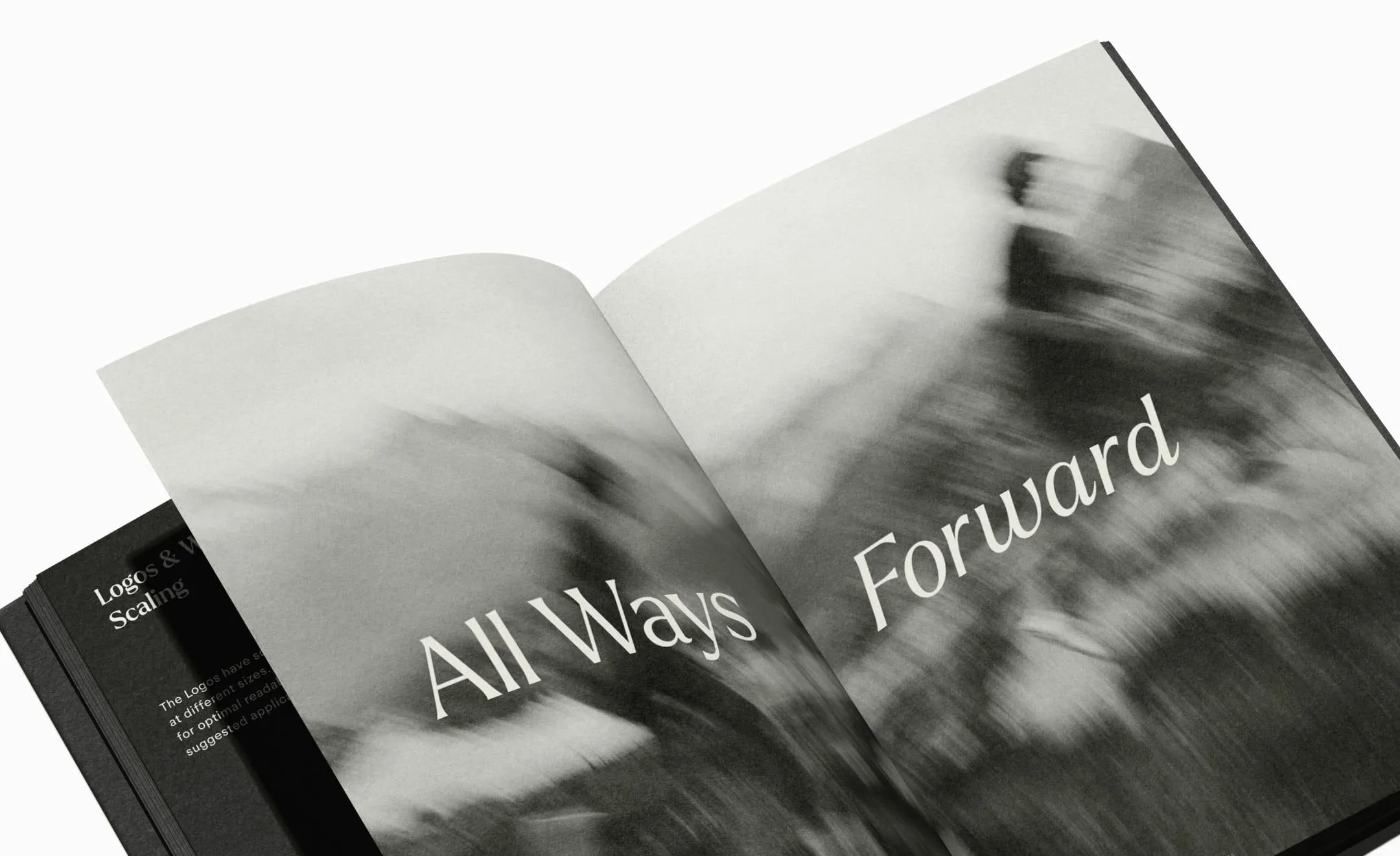 Manual de marca abierto por una doble página en blanco y negro con una foto movida y el lema «All Ways Forward» en letras finas