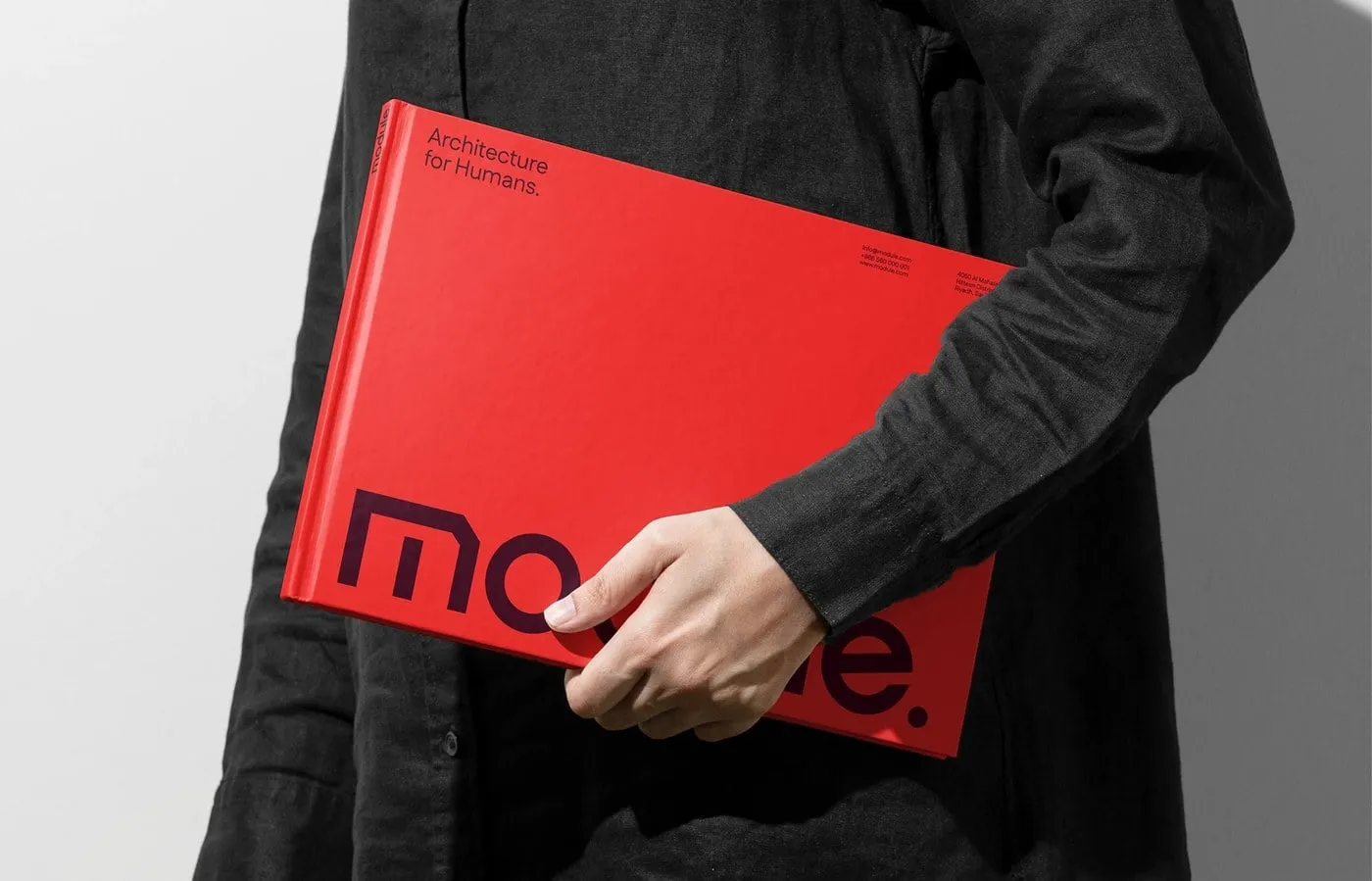 Persona de negro con el monográfico rojo de Module bajo el brazo